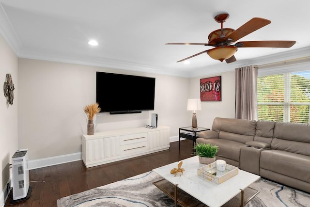 living room with ceiling fan, dark hardwood / wood-style floors, heating unit, and ornamental molding