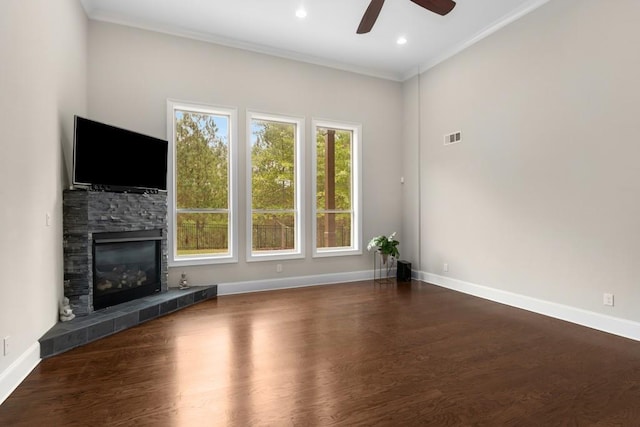 unfurnished living room with ceiling fan, dark hardwood / wood-style floors, crown molding, and a fireplace