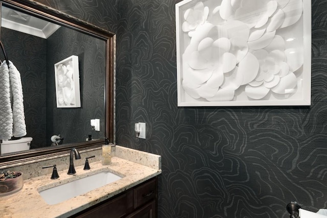 bathroom featuring ornamental molding and vanity