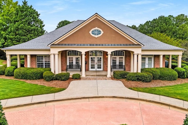 view of front of house featuring a front lawn and french doors