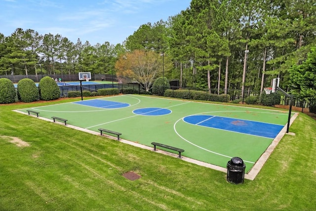 view of sport court with a lawn