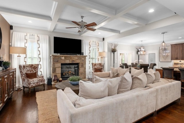 living room featuring dark hardwood / wood-style flooring, a healthy amount of sunlight, beam ceiling, and coffered ceiling