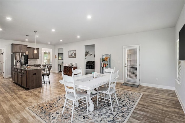 dining space with baseboards, recessed lighting, and light wood-style floors
