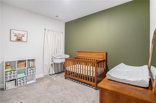 carpeted bedroom with baseboards and visible vents