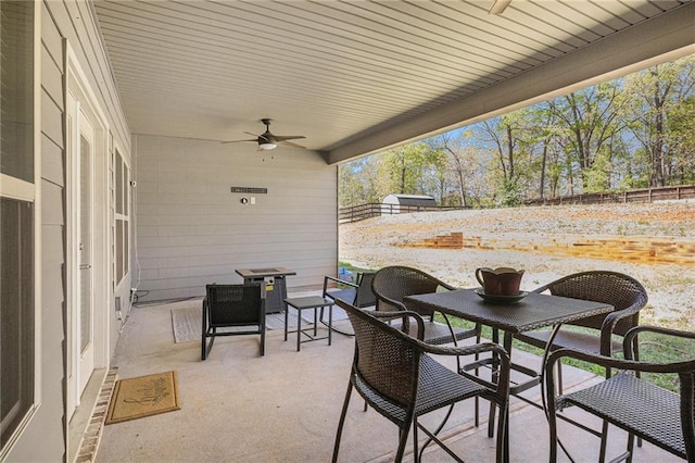 view of patio / terrace featuring ceiling fan and fence