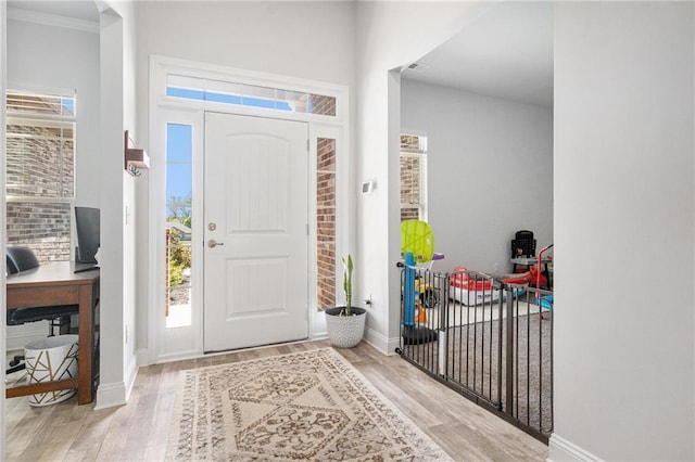 foyer with visible vents, baseboards, and wood finished floors