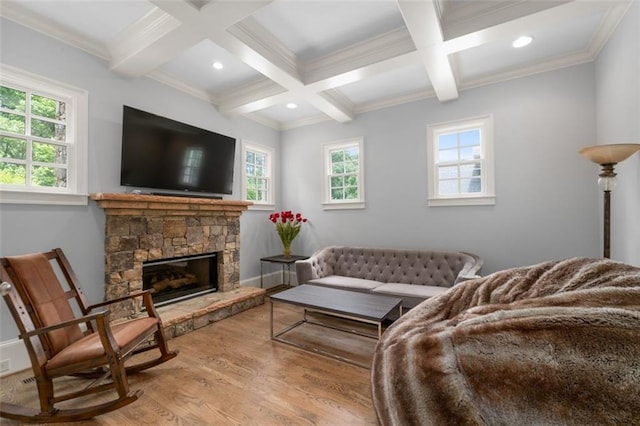 living room with wood finished floors, coffered ceiling, healthy amount of natural light, beam ceiling, and ornamental molding