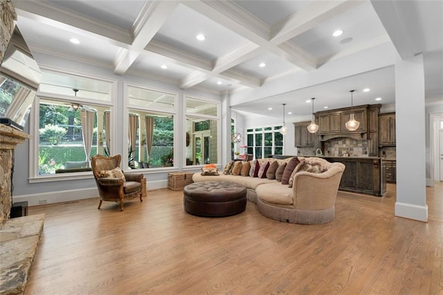 living area with coffered ceiling, light wood finished floors, ornamental molding, beam ceiling, and recessed lighting