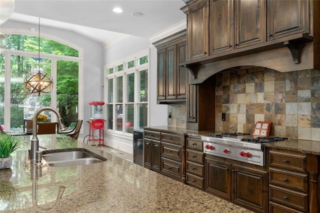 kitchen with a sink, stainless steel gas cooktop, backsplash, light stone countertops, and dark brown cabinets