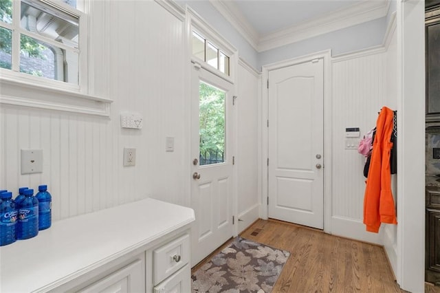 mudroom with ornamental molding and light wood-type flooring