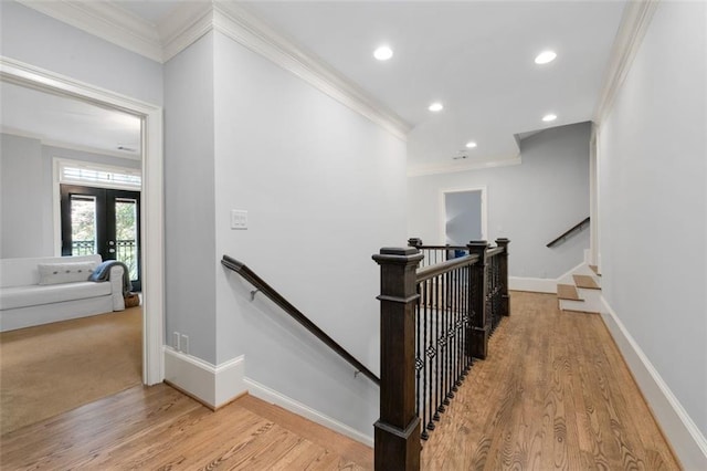 stairs with ornamental molding, french doors, wood finished floors, recessed lighting, and baseboards