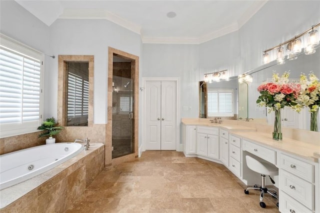bathroom with a jetted tub, a shower stall, vanity, crown molding, and stone finish flooring