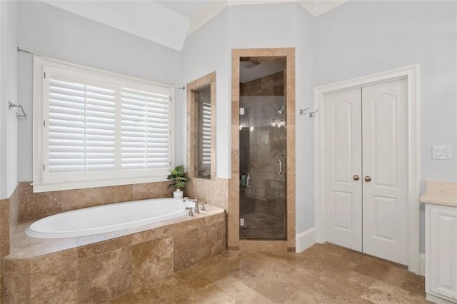 bathroom with a bath and a stall shower