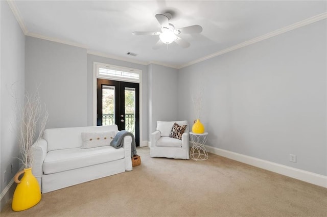 sitting room featuring french doors, carpet flooring, ornamental molding, baseboards, and a ceiling fan