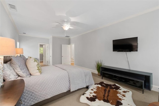 carpeted bedroom featuring ornamental molding, baseboards, and ceiling fan