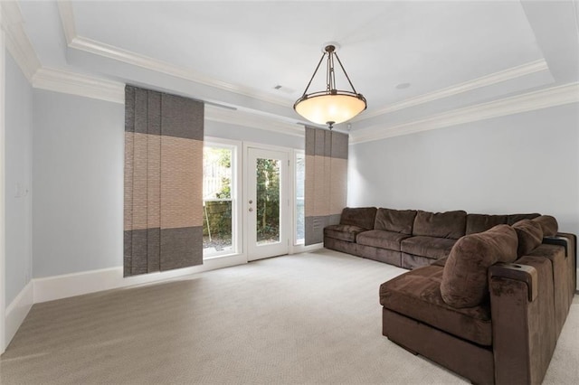 carpeted living room featuring a tray ceiling, crown molding, and baseboards