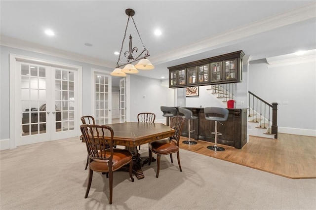dining room with crown molding, french doors, stairway, bar, and recessed lighting