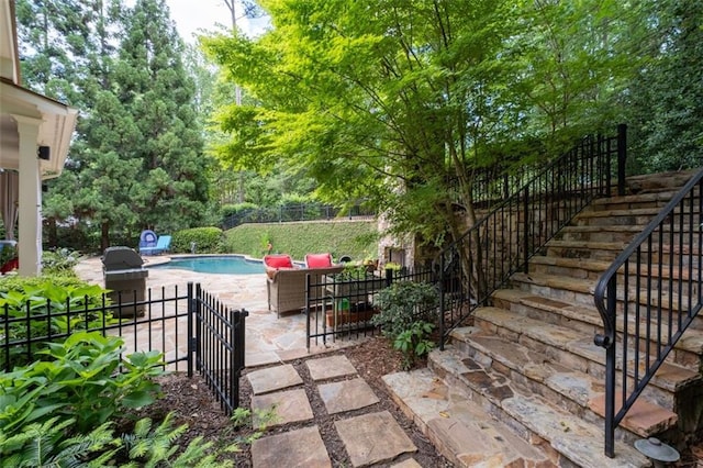 view of patio with a fenced backyard, stairway, and grilling area