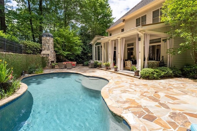 view of pool featuring a patio area and fence
