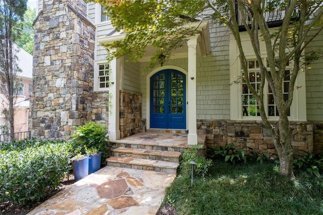 entrance to property featuring stone siding