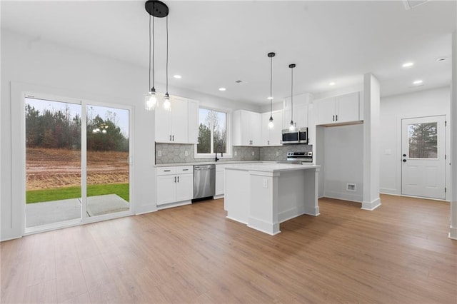 unfurnished dining area with light hardwood / wood-style flooring