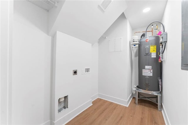 interior space with water heater, washer hookup, hardwood / wood-style flooring, and hookup for an electric dryer