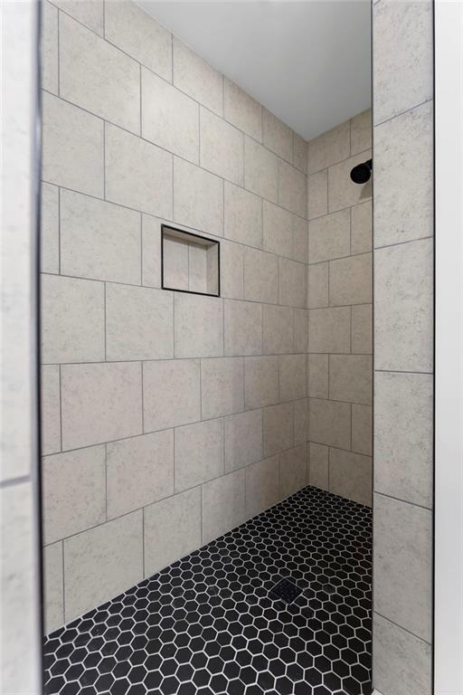 bathroom with a tile shower