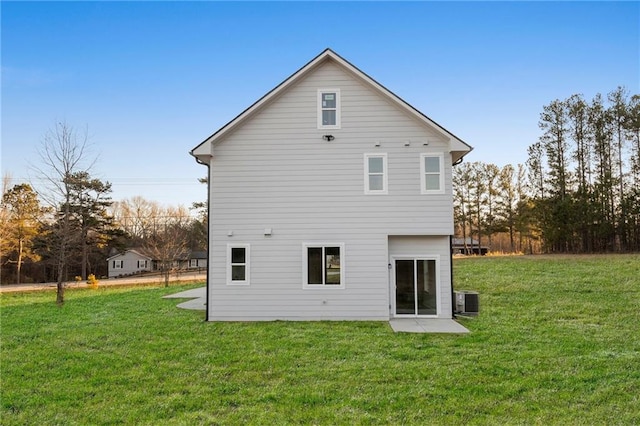 back of property featuring a yard and central air condition unit