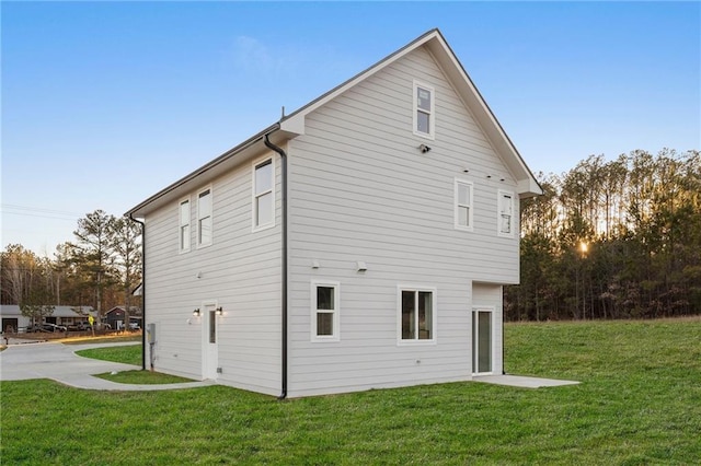 view of property exterior with a lawn