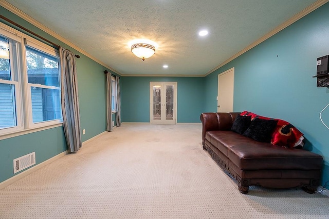 living room featuring crown molding, carpet, and a textured ceiling