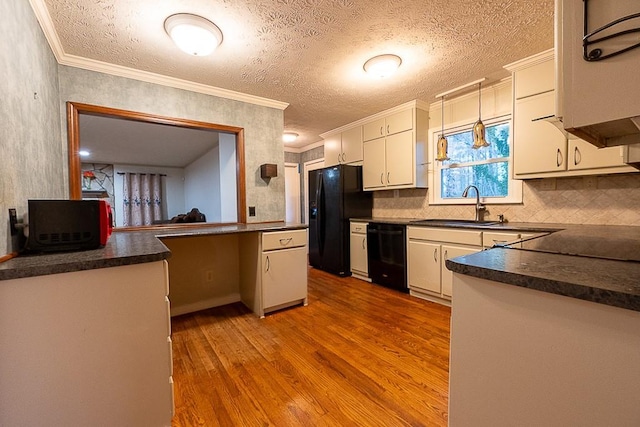 kitchen with white cabinetry, pendant lighting, light hardwood / wood-style floors, and black appliances