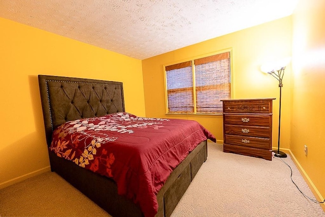 bedroom featuring carpet and a textured ceiling