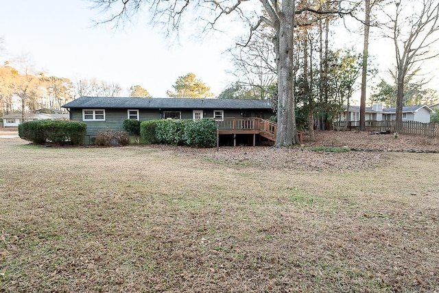 rear view of house with a yard and a deck