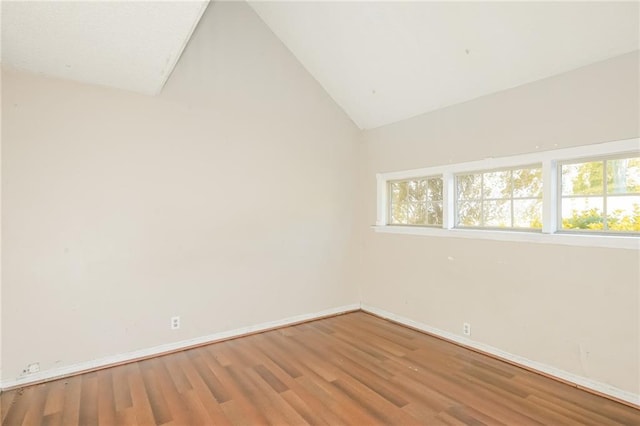 2325 E Hill Way, Norcross, GA 30071 - empty room with wood finished floors, baseboards, and vaulted ceiling