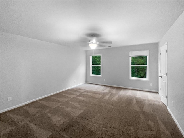 empty room with carpet flooring and ceiling fan