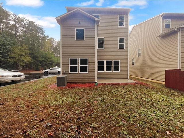 back of house with a patio and a yard