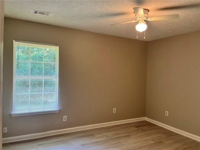 7400 Little Fawn Pkwy, Palmetto, GA 30268 - empty room with wood finished floors, a textured ceiling, and ceiling fan