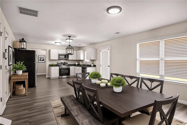 325 Nutwood Trce, Locust Grove, GA 30248 - dining area featuring baseboards and dark wood-style floors