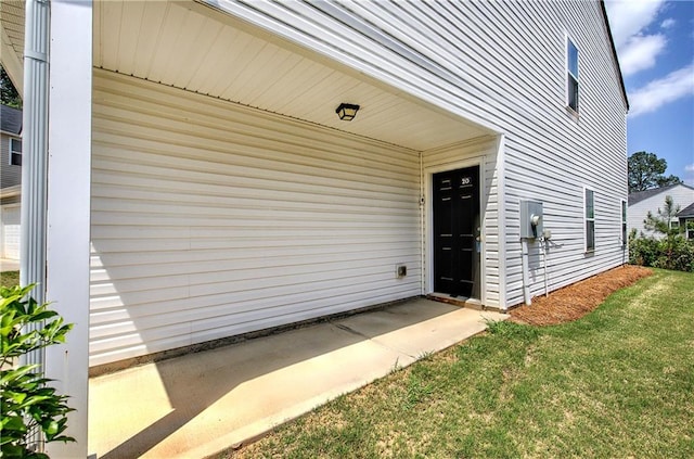 view of exterior entry with a lawn