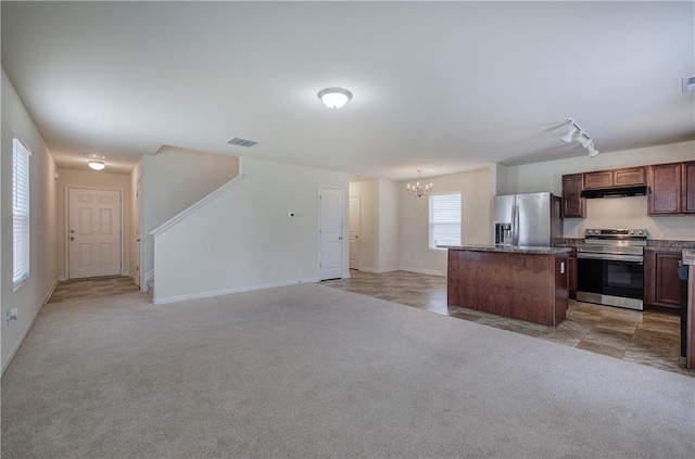 kitchen featuring an inviting chandelier, visible vents, light colored carpet, under cabinet range hood, and stainless steel appliances