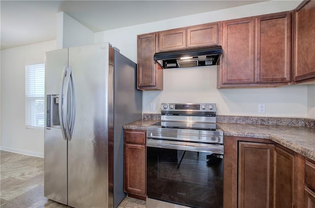 kitchen featuring dark countertops, appliances with stainless steel finishes, and ventilation hood
