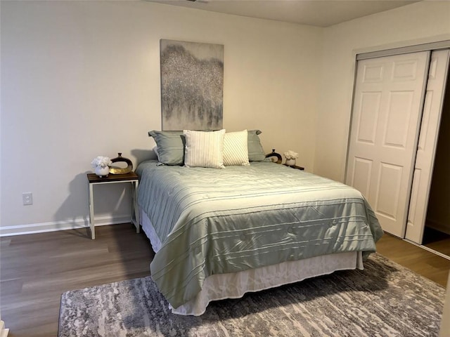 bedroom featuring a closet and dark hardwood / wood-style floors