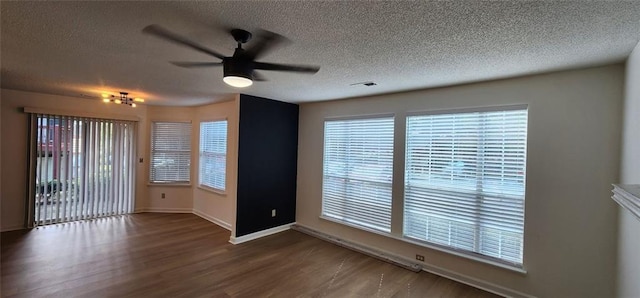 spare room featuring ceiling fan, dark hardwood / wood-style flooring, and a textured ceiling