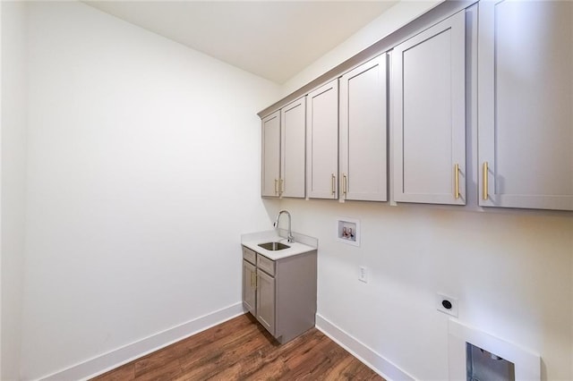 laundry room featuring hookup for an electric dryer, dark hardwood / wood-style floors, washer hookup, cabinets, and sink