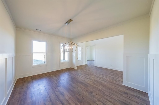 unfurnished dining area with a chandelier, crown molding, and dark hardwood / wood-style flooring