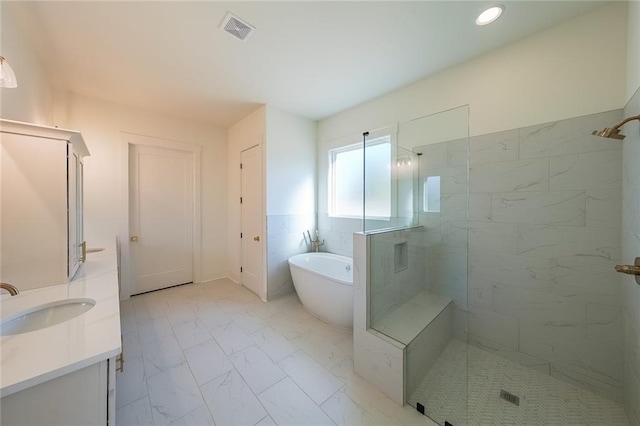 bathroom with vanity and independent shower and bath