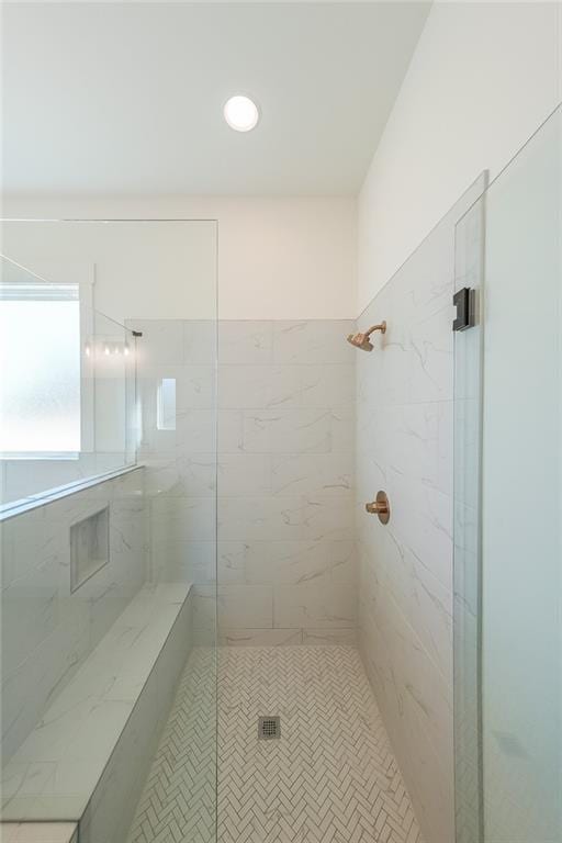 bathroom with tiled shower