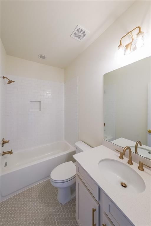 full bathroom with toilet, vanity, and tiled shower / bath