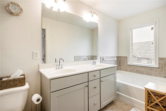 bathroom with vanity, toilet, tile patterned flooring, and a washtub