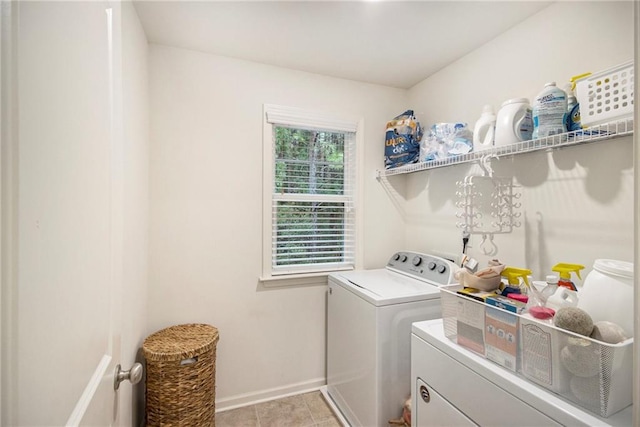 clothes washing area featuring washing machine and dryer and light tile patterned flooring